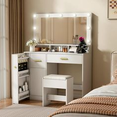 a white vanity with lights on it in a bedroom