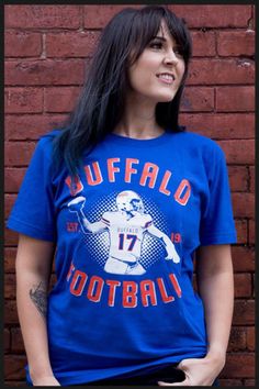 Buffalo Football Shirt. A homage shirt to our new franchise QB. A great shirt for some one who is Buffalo Football fan too! All of our shirts are printed on high quality, ultra soft, 100% cotton preshrunk American Apparel t-shirts. All printing is done in-house and is American made. Main design is on front. for more shirts visit our site: www.mybuffaloshirt.com Sports Fan T-shirt With Short Sleeves, Tri-blend T-shirt With Graphic Print For Fans, Blue Graphic Print T-shirt For Football Season, Pre-shrunk Band Merch T-shirt For Fan Conventions, Crew Neck T-shirt For Fan Events, Team-colored T-shirt With Sublimation Print For Fans, Graphic Print T-shirt For Football Season Fan Events, Throwback Short Sleeve Pre-shrunk T-shirt, Tri-blend Graphic Print T-shirt For Fan Gear