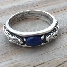 Celtic Dragon Ring With Gemstone Treasure - Medieval Dragon Band Ring. Two Dragons Guard The Crown Treasure! .925 Sterling Silver - With Genuine Lapis Lazuli Gemstone. Handcrafted In Sterling Silver In The Usa. Unisex Design. 1/4 Inch Wide. This Item Ships In 4 - 5 Days. Ring With Gemstone, Two Dragons, Medieval Dragon, Medieval Rings, Celtic Dragon, Dragon Ring, Lapis Lazuli Gemstone, Unisex Design, Womens Jewelry Rings