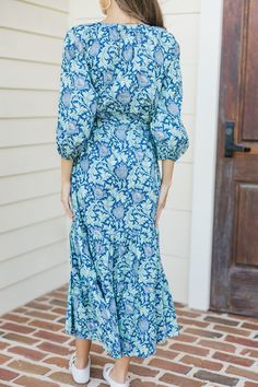 This midi dress is full of good intentions! It's here just to make you look and feel your best! That print is so intricate and we love those hues. This midi dress is going to be perfect for Sunday morning church, attending fall weddings, or family photos! V-neckline Half bubble sleeves Tied waist Floral print No stretch Sydney is wearing the small. Modest Blue Floral Print Dress, Blue Floral Print Midi Dress, Blue Bohemian Knee-length Dress, Blue Printed Maxi Dress, Printed Midi Dress For Vacation, Printed Mid-length Midi Dress For Vacation, Printed Midi Maxi Dress For Brunch, Blue Modest Dress For Garden Party, Printed Long Midi Dress For Brunch