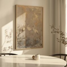 a painting hanging on the wall next to a table with two vases sitting on it