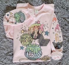 This Hocus Pocus Sisters Sweatshirt is sure to make a magically cozy statement! Show off your spellbinding style and stay comfortable all season long. Now that's witchcraft we can get behind. Pink & Ash Hanes Crewneck Sweatshirt Sublimation Unisex style True to size Sand Gildan Crewneck Sweatshirt Sublimation Unisex style True to size Ash Hanes Hooded Sweatshirt Sublimation Unisex style True to size Note: Colors may vary across computer or phone screens, therefore colors may be slightly differen Hocus Pocus Merch, Hocus Pocus Shirts, Hocus Pocus Sisters, Hocus Pocus Shirt, Sanderson Sisters Hocus Pocus, Sanderson Sisters, Product Ideas, Halloween Sweatshirt, Hocus Pocus