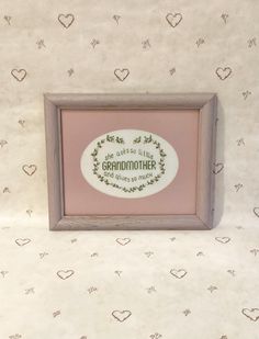 there is a framed picture with the words grandmother and hearts on it in front of a wallpapered background