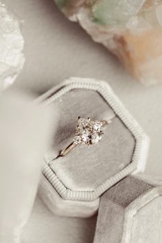 an engagement ring sits in a velvet box