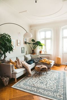 a living room filled with furniture and a rug