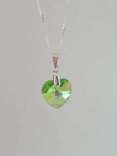 A green Swarovski crystal heart pendant necklace It comes ith a sterlin silver chain - 16 or 18 ins The length of the pendant is approx 1 ins and is attached to a silver plated bail It will come wrapped in tissue paper inside a silver bustina Green Sterling Silver Pendant Crystal Necklace, Silver Heart Cut Necklace For May Birthstone, Green Sterling Silver Heart Pendant Necklace, Green Heart-shaped Sterling Silver Necklace, Green Sterling Silver Necklace With Heart Charm, Swarovski Crystal Hearts, Crystal Heart Pendant, Necklace Swarovski, Crystal Heart