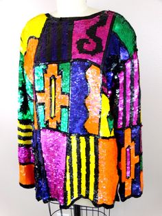 "This is another fab vintage top fully embellished with vibrant sequins and beads in a colorful geometric design. It's in excellent condition! Bust - 42/44\" Waist - 40/42\" Shoulders - 21\" Sleeves - 23\" Top to Bottom - 29\" Tag Size - (no tag size, please refer to measurements) All of my items come from a smoke-free and pet-free home. If you have any questions, please don't hesitate to ask!" Multicolor Party Tops For Festivals, Multicolor Tops For Party And Festivals, Festival Multicolor Sequined Tops, Multicolor Sequined Tops For Festivals, Vintage Multicolor Tops For Party, Vibrant Multicolor Party Tops, Embroidered Tops For Party And Festivals, Multicolor Long Sleeve Festival Top, Multicolor Long Sleeve Tops For Festival