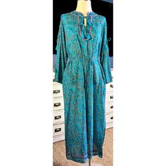 New With Tags Size Medium This Stunning Midi Dress Is A Gorgeous Teal Color With A Hand Blocked Swirling Abstract Floral Pattern. The 100% Organic Cotton Dress Has A Tie Waist. The Neckline Also Has Two Ties. The Sleeves Are Each Held Together With Two Ties. It Has A Border Of Pink Piping On The Neck & Back. It Is Missing Its Slip. Due To Its Handmade Nature, Some Of The Dye Is Darker In Some Spots Than Others, This Is Best Seen In The Pictures Of The Torso On The Right Side Of The Dress Form. M Blue Floral Print Midi Dress In Viscose, Blue Floral Print Viscose Midi Dress, Blue Floral Print Viscose Dress, Green Bohemian Viscose Dress, Blue Flowy Viscose Midi Dress, Bohemian Viscose Midi Dress, Elegant Blue Rayon Maxi Dress, Flowy Viscose Tunic Dress, Blue Viscose Midi Dress