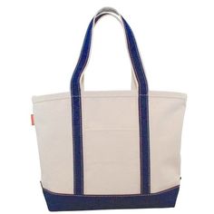 The Classic Canvas Boat Tote is a nautical icon! A must-have for a day on the boat, or at the beach, it also doubles as a sturdy shopping/grocery tote or a versatile everyday accessory for toting everything from work shoes to sports gear. Each bag is made from heavy-duty 18 oz. canvas with reinforced canvas handles. The natural color canvas is accented in navy contrasting trim at the bottom and along the handles. The canvas is stiff enough for the bag to stand up on its own, which makes filling Boat Tote, Picnic Cooler, Navy Bag, Grocery Tote, Classic Bags, Lunch Tote, Monogram Styles, Everyday Accessories, Sports Gear