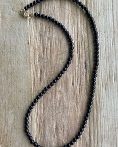 Black Onyx Necklace: Classic Beauty, Made Your Way! https://kathybankston.com/products/black-onyx-necklace-with-sterling-silver-clasp-4mm #blackonyxjewelry #blackonyxnecklace #jewelry #necklace #handmadejewelry #shopsmall #timelessjewelry #classicjewelry #texasmakers Single Strand Necklaces With Round Beads For Layering, Classic Beaded Necklaces With Round Beads For Everyday, Classic Beaded Necklaces With Round Beads, Classic Single Strand Beaded Necklaces, Elegant Black Beaded Necklace With Tiny Beads, Classic Single Strand Beaded Necklace For Everyday, Minimalist 8mm Onyx Bead Jewelry, Elegant Black Tiny Beads, Classic Adjustable Necklace With 8mm Beads