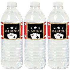 three water bottles with casino themed labels on them