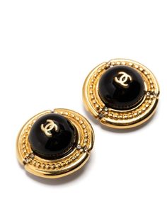 Designed with a large black cabochon set against a gold-toned base, these vintage Chanel earrings feature a beaded detailing embossed into the base, alongside small glimmering rhinestones. Displaying the brand's signature CC logo in the centre, these stunning earrings can be secured using a clip-on fastening. Sweep your hair back and let these stunning earrings take centre stage. Very minor tarnish is visible. Vintage Chanel Earrings, Gucci Jewelry, Hair Back, Centre Stage, Chanel Earrings, Chanel Jewelry, Gold Ounce, Stunning Earrings, Chanel Black