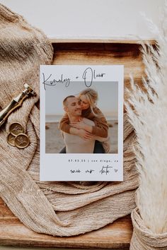 a photo frame with a couple's wedding day card on it next to a pair of scissors