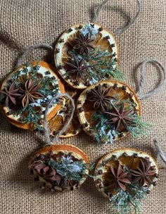 four dried oranges with cinnamon and star anise on them