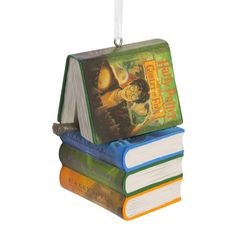 three books stacked on top of each other with a bookmark hanging from the front