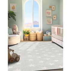 a baby's room with a large window and rugs on the floor in front of it