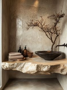 a bathroom with stone walls and a black bowl sink on top of a wooden counter