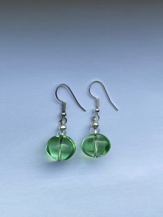 Stunning summer earrings! These have a beautiful sea foam green glass bead!  All earrings are made with a stainless steel wire! Green Teardrop Jewelry For Summer, Green Teardrop Beaded Earrings With Wire Wrap, Green Teardrop Beaded Earrings With Wire Wrapped Detail, Green Teardrop Wire Wrapped Beaded Earrings, Green Wire Wrapped Teardrop Beaded Earrings, Elegant Recycled Glass Earrings With Ear Wire, Green Beaded Pierced Earrings, Nickel-free Green Round Earrings, Nickel Free Round Green Earrings