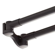 two black metal brackets on the side of a white wall