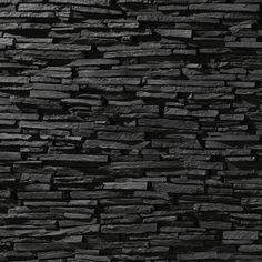 a black stone wall that is very dark