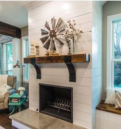 a living room with a fire place next to a window and a tv on the wall