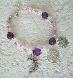 "This beautiful bracelet has pink crackle beads, purple and clear faceted beads, pewter silver accent beads, seed beads, pewter silver charms and a pewter silver pentacle. 7\" long adjustable to 9\" long. Lobster clasp." Jewelry Witchcraft, Witch Bracelet, Wicca Jewelry, Pagan Crafts, Pagan Goddess, Goddess Jewelry, New Plymouth, Wiccan Jewelry, Pagan Jewelry