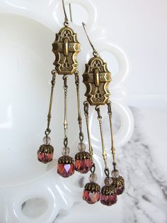 These extra-long earrings are made with beautifully-detailed brass stampings and filigree and Czech glass beads. The beads are a translucent rose pink with an opalescent sheen.  These earrings are 3.5" long from the top of the earring hook to the bottom of the dangles. Without the hook, they are 2.75" long. ------------------- **Please be sure to read my shipping and store policies, and don't hesitate to send me a message with any questions you may have! INTERNATIONAL BUYERS: Please be aware that there may be taxes or customs fees that are not included in the purchase price. I cannot reimburse for additional fees. Extra Long Earrings, Duster Earrings, Long Duster, Earring Hook, Vintage Style Jewellery, Le Crochet, Pink Opal, Style Jewelry, Czech Glass Beads