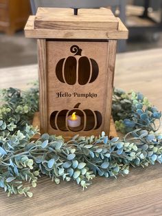 a wooden box with a candle in it sitting on a table