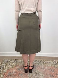 Inspired by the romantic toughness of New York City, this cargo style skirt has godet panel to give it a flare silhouette. Rendered in Italian cotton wool twill, giving a clean modern look but soft to the touch. Accented with high polish snaps details. Content + Care: 70% Cotton, 21% Viscose, 9% Wool. Professional dry clean only. Kids Stationary, Godet Skirt, Denim Blouse, Cargo Style, Style Skirt, Cotton Wool, Sneaker Wedge, Clean Modern, Sweater Skirt