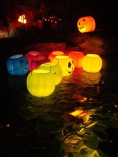 glowing pumpkin lanterns in the water at night