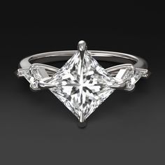 a princess cut diamond ring with three side stones on the band and an arrow shaped center stone