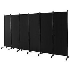 a room divider with wheels on each side and four panels in the same color