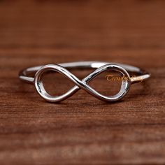 Minimalist Sterling Silver Infinity Ring, Infinity Symbol Promise Ring ▷Gift Box Included ▷5mm Height ▷Size 3 - 13 Available ▷925 Sterling Silver (not plated or filled) ▷925 Stamp Authenticity https://www.etsy.com/shop/TrendyRing Adjustable Infinity Ring For Mother's Day, Mother's Day Infinity Adjustable Rings, Adjustable Infinity Stackable Rings Gift, Adjustable Stainless Steel Stackable Rings, Adjustable Infinity Stackable Rings, Infinity Midi Rings For Anniversary, Anniversary Infinity Midi Rings, Elegant Silver Infinity Midi Rings, Minimalist Infinity Rings With Adjustable Fit