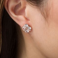 With a touch of floral charm, these lovely stud earrings are sure to become an instant favorite. Crafted in precious 10K rose gold, each pretty earring showcases a quartet of 5.0mm lab-created shimmering white sapphires. The sculpted flower-shaped center design sparkles with a diamond accent. Buffed to a brilliant luster, these post earrings secure comfortably with friction backs. Elegant Rose Gold Cubic Zirconia Flower Earrings, Rose Gold Cubic Zirconia Flower Earrings For Formal Occasions, Formal Rose Gold Cubic Zirconia Flower Earrings, Elegant Pink Gold Flower Earrings, Classic Rose Gold Flower Shaped Jewelry, Formal Rose Gold Flower Earrings, Rose Gold Flower-shaped Earrings With Prong Setting, Rose Gold Flower Shaped Earrings With Prong Setting, Rose Gold Flower-shaped Jewelry With Matching Earrings