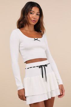 It's easy to collect new crushes while you're wearing the Lulus Ever So Charmed Ivory Bow Tiered Two-Piece Mini Sweater Dress! Lightweight sweater knit shapes this adorable two-piece dress that features a long-sleeved crop top with a flattering scoop neckline and a contrasting, black satin bow detail at the center. The A-line skirt has an elasticized waistband that boasts a matching, black stitched design, with satin threading that ties with a cute bow at the front. Tiered mini hem completes the Black Bow Dress, Knitted Skirt, Mini Sweater, Bow Dress, Graduation Outfit, Mini Sweater Dress, Satin Bow, Lightweight Sweater, Cute Bows