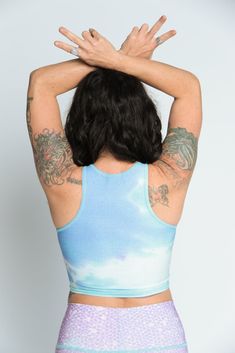 The Teeki Mermaid Tanks are cut with a high neckline and razor back crop top. They can be layered and offer gentle compression for low-impact workouts, yoga, swimming, and everyday layering. Fit: The single layer of lightweight fabric offers a gentle compression for low impact activities and daily use. Move freely in yoga class, by the pool, in the ocean, or layering without the discomfort of tight elastic bands, thick materials and underwires. If you have a small chest size the fit may not be t Blue Crop Top With Built-in Bra For Gym, Blue High Neck Stretch Tank Top, Blue Stretch High Neck Tank Top, Blue Fitted High Neck Tank Top, Fitted High Neck Blue Tank Top, Stretch High Neck Yoga Tops, High Neck Stretch Tops For Yoga, Stretch High Neck Tops For Yoga, High Neck Stretch Yoga Tops