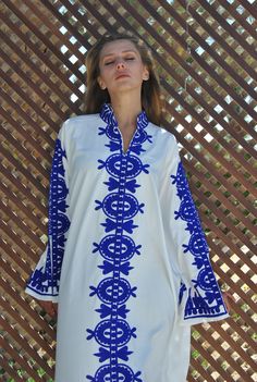 A stunning Kaftan dress that is simple, elegant, and classy! Feel like a Mediterranean queen with the flowing vibrant monotone embroidery that strikes memories of your favourite getaway. The dress is made of Egyptian cotton that has a soft feel to it so you will surely feel comfortable and royal in it. You can wear this Kaftan practically anywhere and for any occasion. You can dress it up with a pair of heels and strut like an Egyptian queen in any gathering, resort, or party. Or you can dress i White Embroidered V-neck Kurta, Elegant Straight Kurta Kaftan For Summer, Elegant Spring Kaftan With Straight Kurta, Elegant Straight Kurta Kaftan For Spring, Blue Embroidered Straight Kurta Kaftan, Elegant White Straight Kurta Kaftan, Elegant Long Sleeve Kurta With Geometric Embroidery, Summer Blue Kurta With Embroidered Neckline, Blue Summer Kurta With Embroidered Neckline