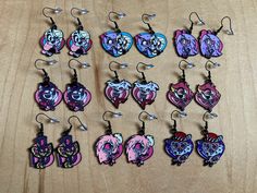 These earrings were handmade by me using black zinc-free & nickel-free ear wire hooks and heart-shaped enamel charms based on Hazbin Hotel.  All materials are new and nickel-free from a smoke-free and cat-friendly home. I used to have Alastor as an option, but I'm having issues with my suppliers.  I'm unsure if I'll be able to bring him back. If you have any questions, feel free to message me! Hazbin Hotel Bracelet Ideas, Hazbin Hotel Rings Of Hell, Hazbin Hotel Earrings, Charlie Merch Hazbin Hotel, Alastor Charlie, Hazbin Hotel Valentines Day Merch, Cat Friendly Home, Simi Valley, Cat Friendly