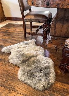 a sheepskin rug is on the floor next to a chair