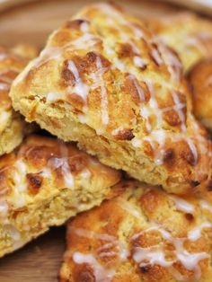 some biscuits are sitting on a plate with white glaze and drizzled