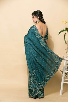 Expertly crafted teal blue zardozi saree with stonework and floral embroidery. Perfect for any special occasion, this traditional Indian piece exudes elegance and luxury. Timeless design and comfortable fit. Designer Embroidered Turquoise Lehenga, Designer Turquoise Embroidered Lehenga, Traditional Turquoise Dupatta With Intricate Embroidery, Elegant Blue Embroidered Dola Silk Fabric, Traditional Turquoise Embroidered Dupatta, Blue Traditional Pre-draped Saree With Intricate Embroidery, Blue Dola Silk Saree With Zari Work, Unstitched Blue Pre-draped Saree With Intricate Embroidery, Blue Pre-draped Saree With Intricate Embroidery For Diwali