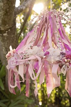 pink and white flowers hanging from a tree