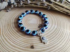 The Blue Evil Eye bracelet provides spiritual protection that acts as a 'repellent' to any negative energy directed at you so that you would be protected and safe.  Made with stretch cord and evil eye beads. CARE INSTRUCTIONS: 🧿 Store your beloved jewelry in a cool dry place. 🧿 Best not to wear when taking a bath or swimming. 🧿 Remove when sleeping, exercising, or doing other physically strenuous activities. 🧿 Care should be used to avoid overstretching.  🧿 Simple care of the bracelets will Adjustable Evil Eye Bracelets For Meditation, Symbolic Adjustable Bracelet With 108 Beads, Spiritual Healing Evil Eye Bracelet With Round Beads, Blue Spiritual Stretch Bracelet For Meditation, Blue Spiritual Stretch Bracelet With Round Beads, Adjustable Blue Symbolic Bracelet, Adjustable Spiritual Evil Eye Bracelet For Meditation, Blue Spiritual Beaded Bracelets, Spiritual Blue Beaded Bracelets