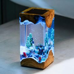 a wooden box with an aquarium inside on a table