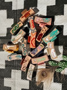 a pile of wooden magnets sitting on top of a black and white checkered table cloth