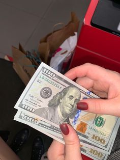 a woman is holding money in her hand