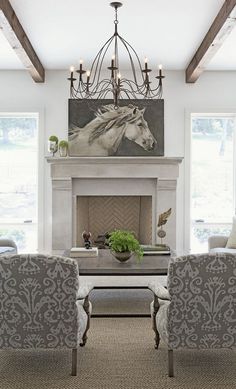 a living room filled with furniture and a fire place in front of a painting on the wall