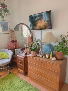 a living room filled with furniture and a flat screen tv mounted to the side of a wall