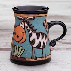 a ceramic mug with a zebra painted on it