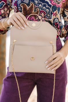 This taupe purse is the definition of classic and chic! The contrasting fabric is gorgeous and we love the gold hardware. This clutch is going to look amazing with so many dressier outfits. Elegant Everyday Gold Shoulder Bag, Workwear Clutch With Gold-tone Hardware, Classic Clutch With Detachable Strap For Work, Elegant Workwear Bag With Fold Over Clasp, Elegant Formal Shoulder Bag For Spring, Chic Taupe Shoulder Bag For Work, Classic Taupe Evening Bag, Chic Formal Shoulder Bag For Spring, Taupe Shoulder Bag With Gold-tone Hardware For Formal Occasions